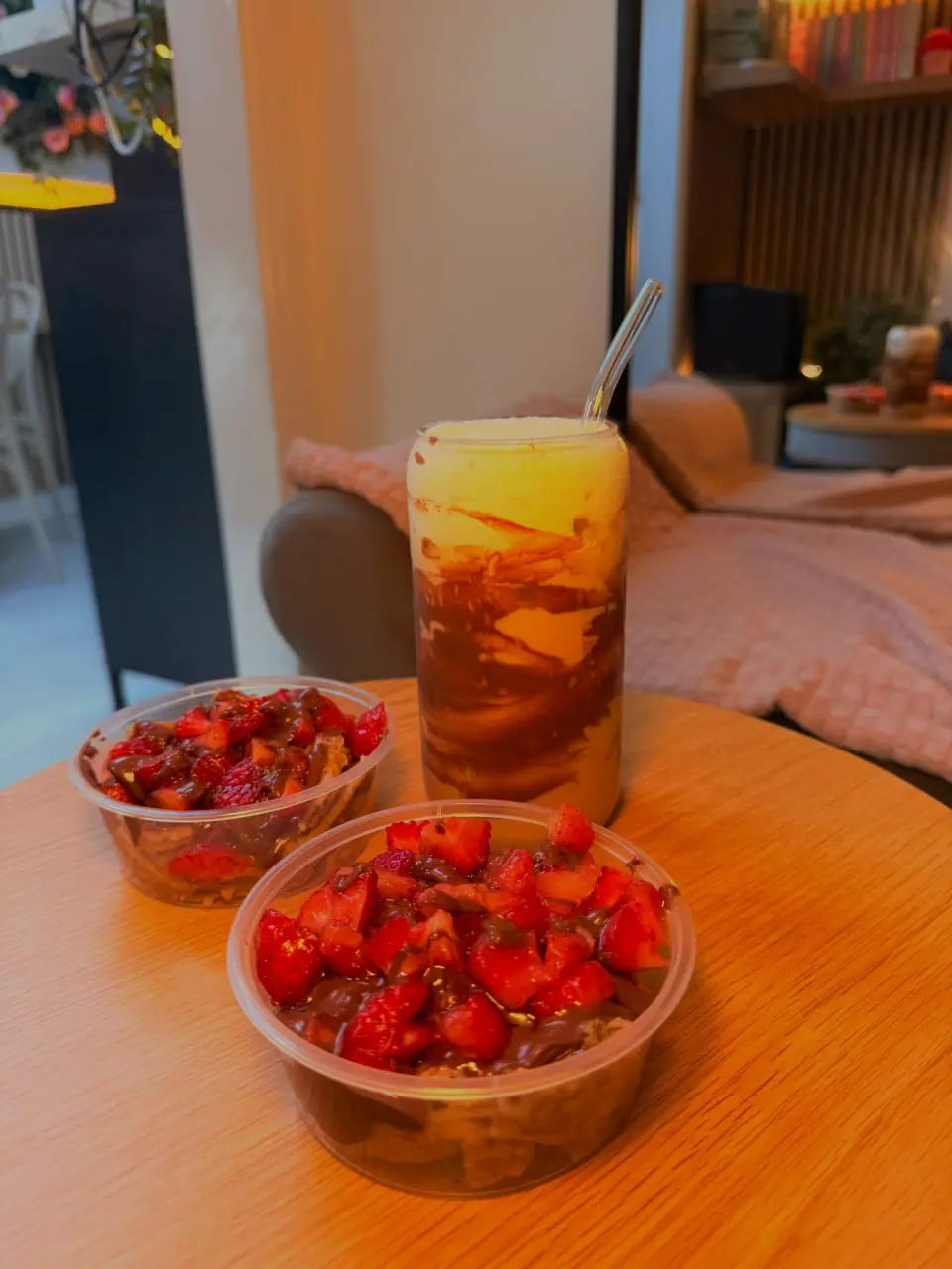 A chocolate-swirled drink and strawberry dessert bowls at Tina Rose