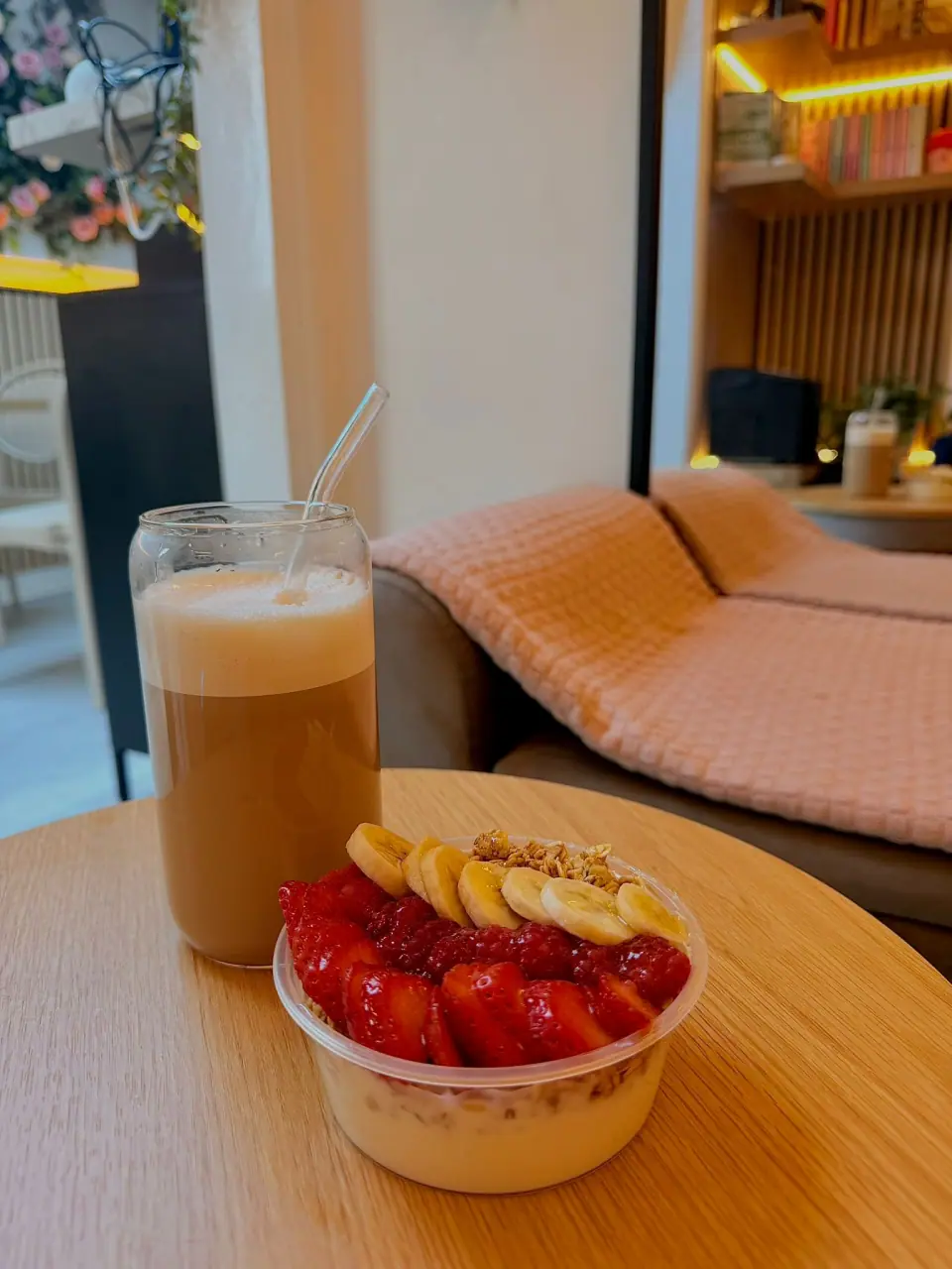 Strawberry, banana and granola yogurt bowl with an iced latte
